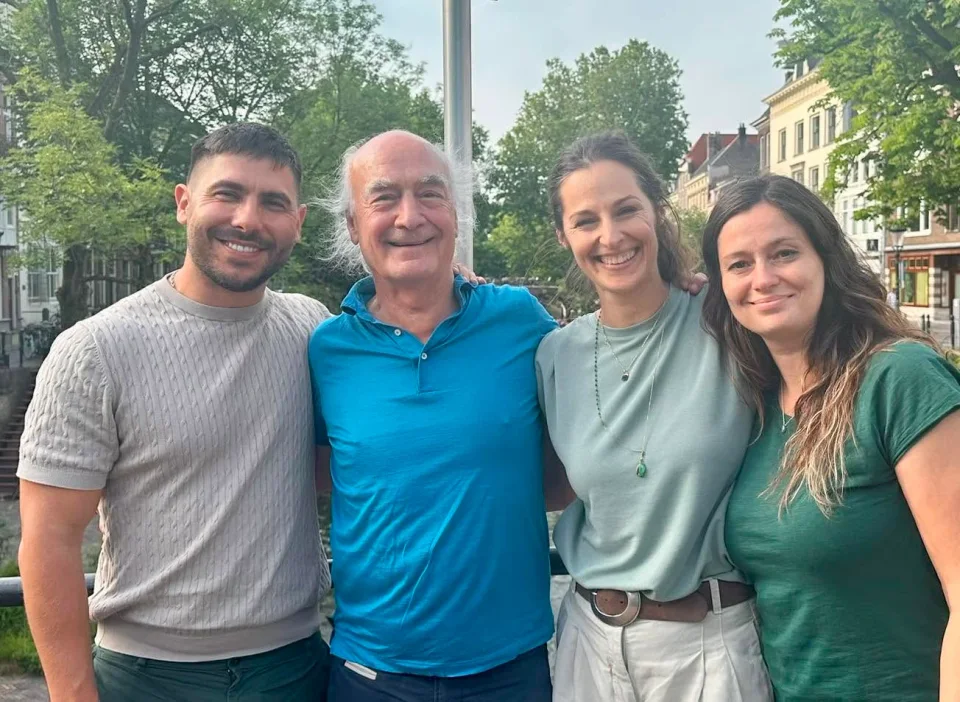 Group photograph of four people by a canal